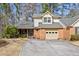 Charming home featuring a brick facade, attached garage, and meticulously landscaped front yard at 6 Dover Trl, Peachtree City, GA 30269