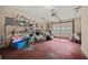 Spacious garage featuring storage shelves with neatly arranged belongings and a roll-up door at 6 Dover Trl, Peachtree City, GA 30269