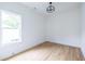 Clean bedroom with light wood floors, white walls, and modern geometric light fixture at 63 Holly Nw Rd, Atlanta, GA 30314