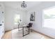 Bright office space with light wood floors, a neutral rug, and a modern desk beneath a stylish light fixture at 63 Holly Nw Rd, Atlanta, GA 30314