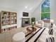 Bright living room featuring a stone fireplace, large windows and neutral decor creating a comfortable atmosphere at 3213 Cedar Bluff Ne Dr, Marietta, GA 30062