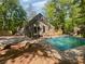 Backyard with pool, deck, and wooded area providing a private outdoor space for relaxation and recreation at 3213 Cedar Bluff Ne Dr, Marietta, GA 30062