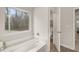 Bright bathroom with a large tub and picture window providing plenty of natural light at 565 Abbott Se Ct, Atlanta, GA 30354