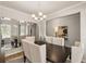 Modern dining room with chandelier, mirror, and hardwood floors at 565 Abbott Se Ct, Atlanta, GA 30354