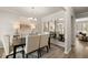 Dining room with a dark wood table, neutral chairs, and a large mirror at 565 Abbott Se Ct, Atlanta, GA 30354