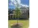 Charming brick home with a well-manicured lawn and a newly planted tree in the front yard at 565 Abbott Se Ct, Atlanta, GA 30354