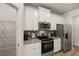 Well-equipped kitchen featuring white cabinets and a pantry at 565 Abbott Se Ct, Atlanta, GA 30354