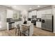 Open concept kitchen with island, white cabinets and stainless steel appliances at 565 Abbott Se Ct, Atlanta, GA 30354