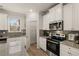 Modern kitchen with granite countertops and stainless steel appliances at 565 Abbott Se Ct, Atlanta, GA 30354