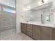 Elegant bathroom with double vanity, large mirror, and a walk-in shower at 5235 Maggie Mae Ln, Cumming, GA 30028