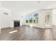 Bright living room with hardwood floors, large windows, and a cozy fireplace at 5235 Maggie Mae Ln, Cumming, GA 30028