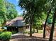 Exterior view of the community clubhouse with lush greenery, lake, and a walkway at 5432 Post Road Pass, Stone Mountain, GA 30088
