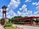 Community entrance with clock tower, pergola, landscaping, and welcome sign at 5432 Post Road Pass, Stone Mountain, GA 30088