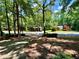 Well-manicured front yard with mature trees, long driveway, and lush greenery at 5432 Post Road Pass, Stone Mountain, GA 30088