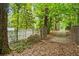 Gated driveway leading to a private property, enhanced by mature trees and a fence at 841 Hickory Dr, Marietta, GA 30064