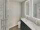Bathroom featuring a glass enclosed shower, a marble countertop vanity, an illuminated mirror, and white tiling at 6941 Gallant Se Cir # 10, Mableton, GA 30126