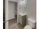 Bathroom with a vanity, mirror with lighting, a toilet, and views to a staircase at 6941 Gallant Se Cir # 10, Mableton, GA 30126