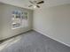 Serene bedroom with soft carpet, a ceiling fan, a large window offering natural light and views of the neighborhood at 6941 Gallant Se Cir # 10, Mableton, GA 30126