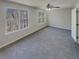 Spacious bedroom with plush carpeting, two large windows overlooking a wooded lot, and a ceiling fan at 6941 Gallant Se Cir # 10, Mableton, GA 30126