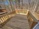 Outdoor wooden deck with wood railing surrounded by trees at 6941 Gallant Se Cir # 10, Mableton, GA 30126