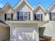 Two story home features gray vinyl siding and well manicured lawn at 6941 Gallant Se Cir # 10, Mableton, GA 30126