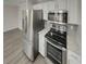 Modern kitchen with white cabinets, stainless steel appliances and gray subway tile backsplash at 6941 Gallant Se Cir # 10, Mableton, GA 30126
