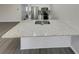 Kitchen featuring quartz countertops, modern appliances and gray vinyl floors at 6941 Gallant Se Cir # 10, Mableton, GA 30126