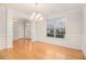 Elegant dining room with hardwood floors, wainscoting, and chandelier at 2036 Broadmoor Way, Fairburn, GA 30213