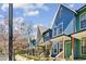 Row of colorful townhomes with front porches and landscaped yards at 1095 Tucker Ave # 106, Atlanta, GA 30310