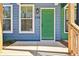 Bright green front door of a new construction townhome with modern windows at 1095 Tucker Ave # 106, Atlanta, GA 30310