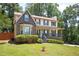 Two-story brick home with covered porch and landscaped yard at 3664 Nessa Se Ct, Smyrna, GA 30082