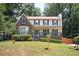 Two-story brick home with covered porch and landscaped yard at 3664 Nessa Se Ct, Smyrna, GA 30082