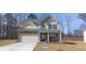 Charming two-story home with stone accents, a two-car garage, and a well-maintained front yard at 6045 Spring Way, Stonecrest, GA 30038