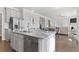 Open concept kitchen featuring a granite island with a dishwasher and stainless steel refrigerator at 6045 Spring Way, Stonecrest, GA 30038