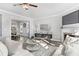 Comfortable living room featuring hardwood floors, fireplace, and modern furnishings at 6045 Spring Way, Stonecrest, GA 30038