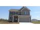 Charming two-story home with a two-car garage and gray siding, perfectly complemented by a well-manicured lawn at 6048 Spring Way, Stonecrest, GA 30038