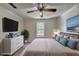 A staged bedroom with neutral walls, a ceiling fan, and serene decor at 102 Gettysburg Pl, Sandy Springs, GA 30350
