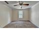 Empty bedroom has neutral carpet, a ceiling fan, and a window view at 102 Gettysburg Pl, Sandy Springs, GA 30350
