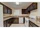 Bright kitchen featuring dark cabinets, marbled countertops, and white appliances at 102 Gettysburg Pl, Sandy Springs, GA 30350