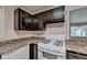 The kitchen features dark cabinets and a white gas range stove at 102 Gettysburg Pl, Sandy Springs, GA 30350