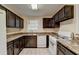 Galley kitchen with dark cabinets, marble countertops, and bright appliances at 102 Gettysburg Pl, Sandy Springs, GA 30350