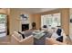 Cozy living room featuring a fireplace, plush seating, and large windows for natural light at 102 Gettysburg Pl, Sandy Springs, GA 30350