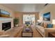 Living room featuring a fireplace, plush seating, and large windows for natural light at 102 Gettysburg Pl, Sandy Springs, GA 30350