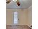 Main bedroom featuring neutral walls, a ceiling fan, and access to outdoor patio at 102 Gettysburg Pl, Sandy Springs, GA 30350