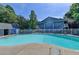 Resort-style swimming pool with a white fence for privacy and security at 102 Gettysburg Pl, Sandy Springs, GA 30350