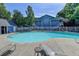Community pool area with lounge chairs for relaxing on a beautiful summer day at 102 Gettysburg Pl, Sandy Springs, GA 30350