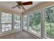 Bright sunroom features a ceiling fan, and large windows with green views at 102 Gettysburg Pl, Sandy Springs, GA 30350
