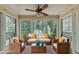 Bright sunroom with ample seating, plants, and large windows to let in natural light at 102 Gettysburg Pl, Sandy Springs, GA 30350