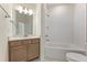 Clean bathroom features a tub, vanity with drawers, and neutral wall tile at 5245 Maggie Mae Ln, Cumming, GA 30028