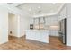 Modern kitchen features an island, stainless steel appliances, and ample cabinet space at 5245 Maggie Mae Ln, Cumming, GA 30028